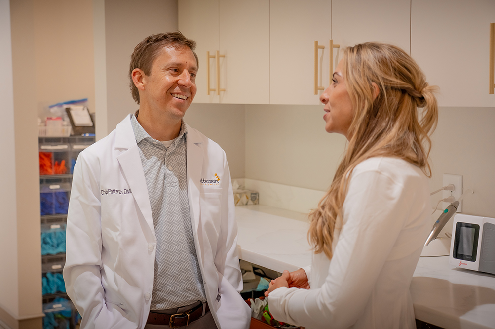 Dr. Chip Patterson talking with a team member in a Hoschton, GA dental treatment room